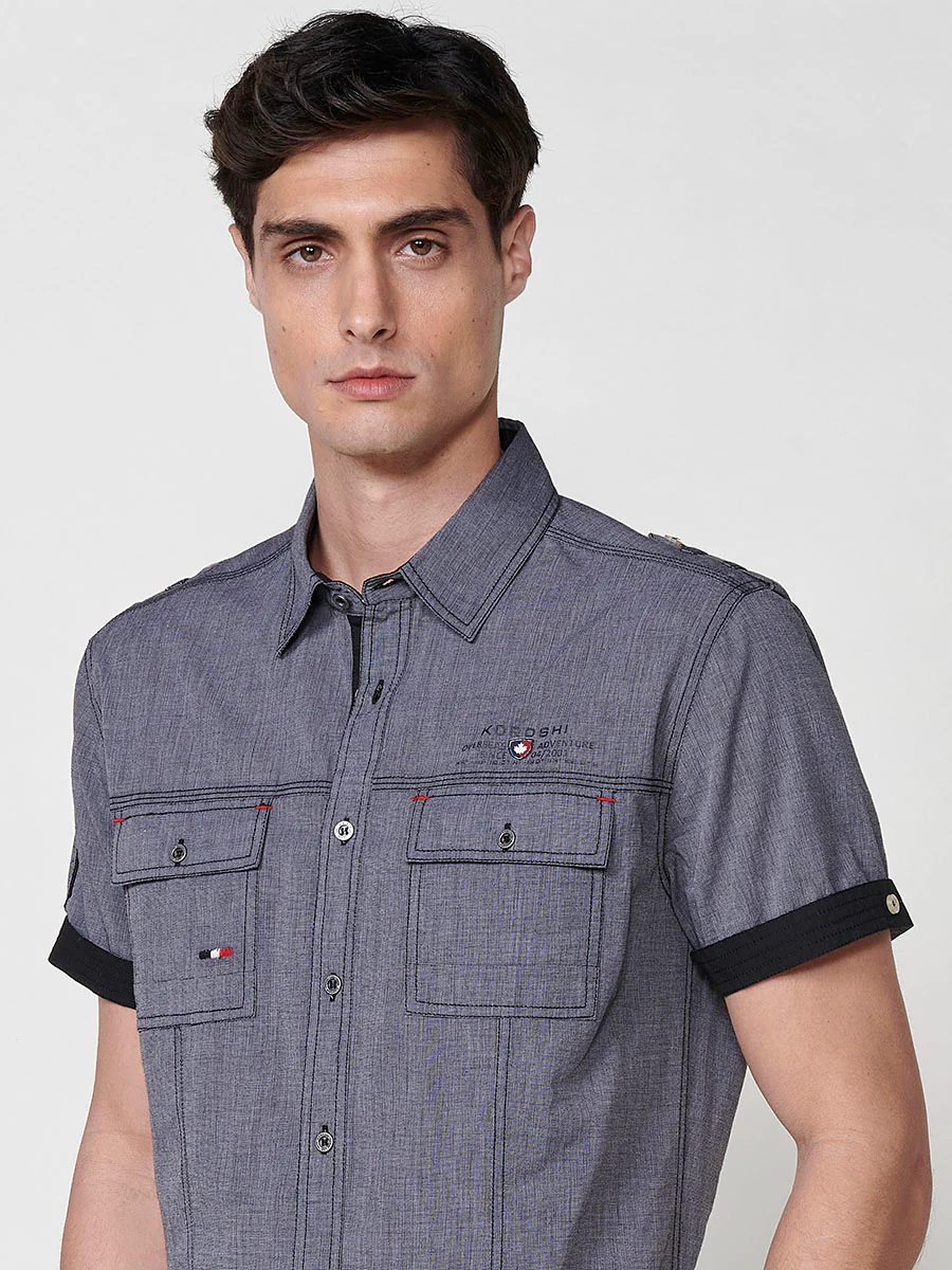 Camisa de manga corta de algodón. puños vueltos, cierre con botones y bolsillos con solapa. - Image 10